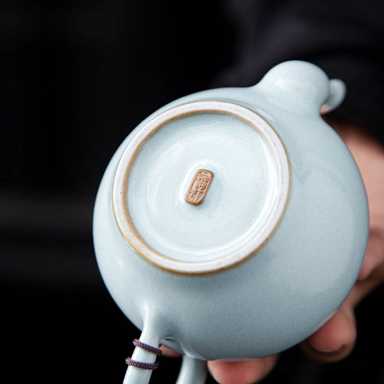 100ml ceramic teapot next to tea cup for size reference