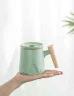 Full 10oz ceramic tea infuser mug with wood handle and mountain relief pattern