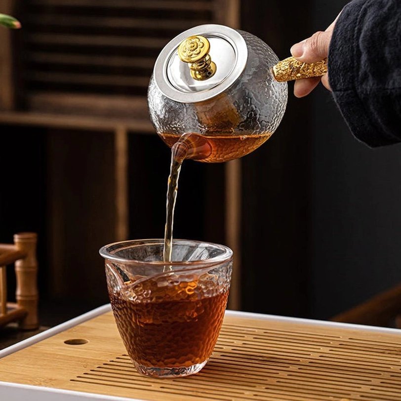 125ml glass kyusu teapot with infuser placed on tea table for use