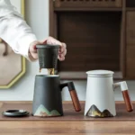 14oz mountain ceramic tea infuser mug with wooden handle, both black and white color variants