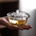 150ml clear glass gaiwan held in hand showing size