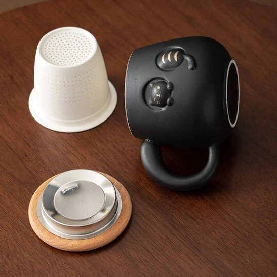disassembled 3d cat tea infuser mug parts: infuser, wood lid, ceramic cup body