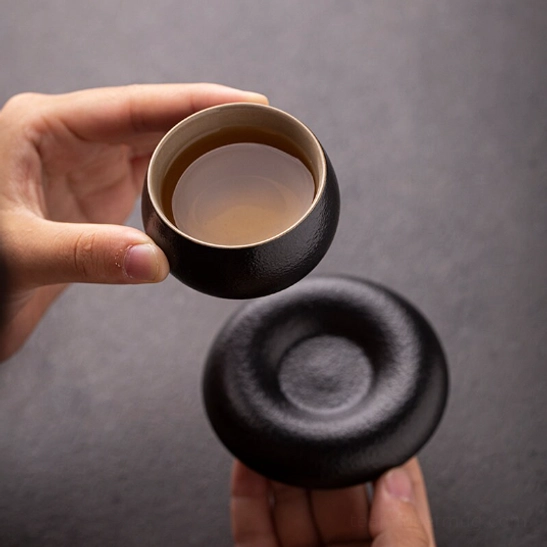 Size comparison of the compact 50ml Japanese tea cup held in hand