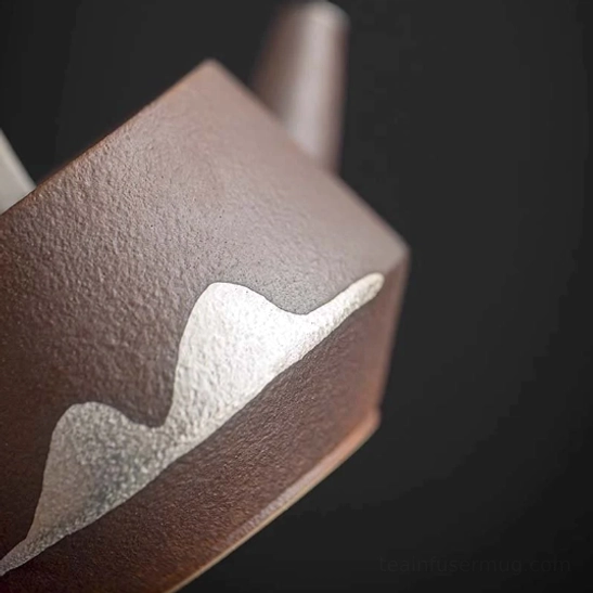 adding loose tea leaves into 180ml faraway mountain ceramic teapot