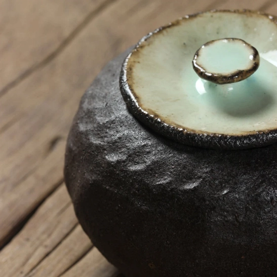 side angle view of compact airtight ceramic tea storage canister