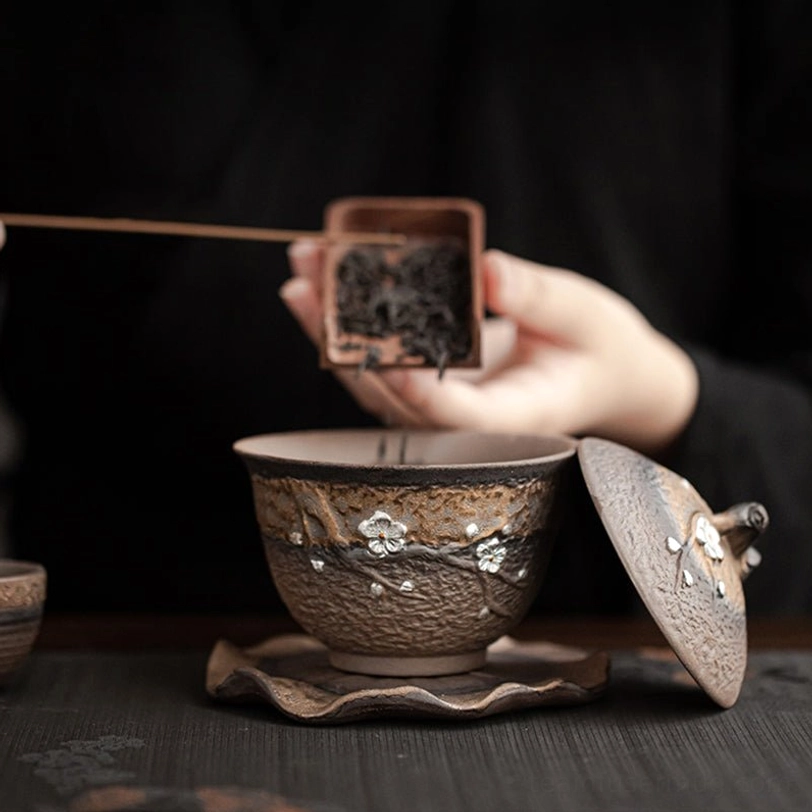 Plum blossom ceramic gaiwan tea cup set angled view on neutral background
