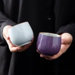 full side view of purple antique style Chinese porcelain tea cup with gold rim