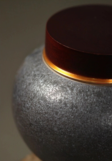 Side shot of assembled golden crane tea storage canister with wooden lid