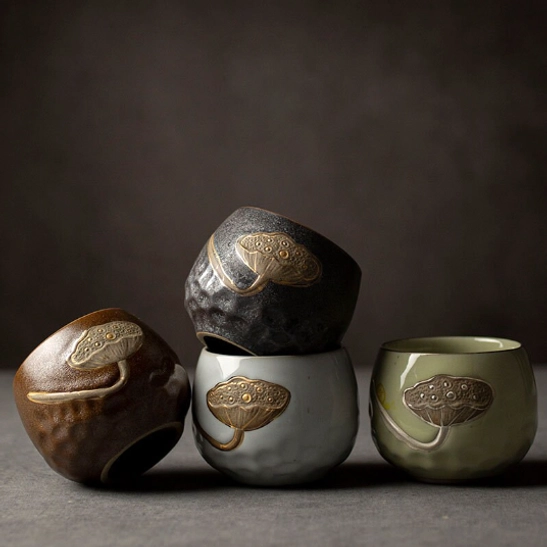 four assorted color lotus chinese tea cups grouped for size reference