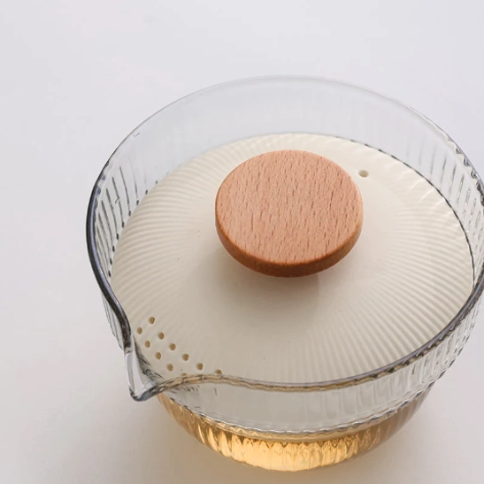 beige travel tea set arranged open on a wooden background