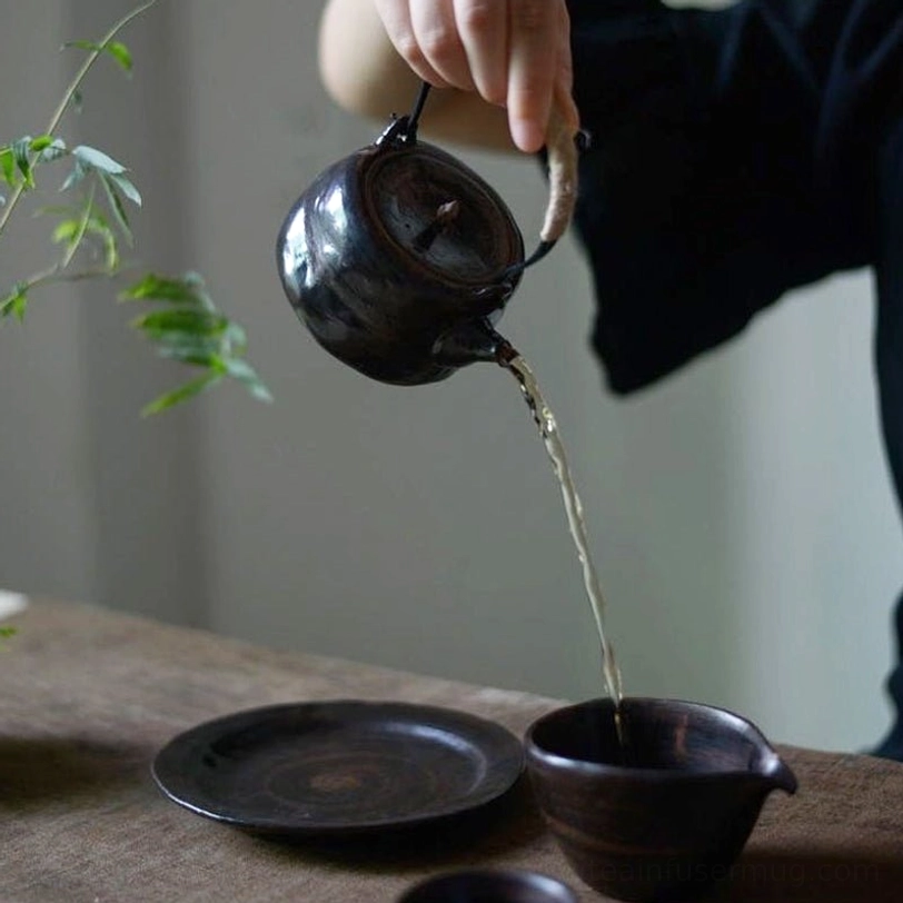 Two wabi-sabi ceramic teapots black and white variants side by side