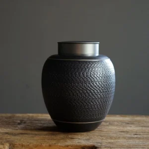 black textured ceramic tea storage canister with sealed metal lid