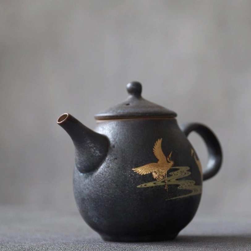bottom view of the golden crane black ceramic teapot with infuser