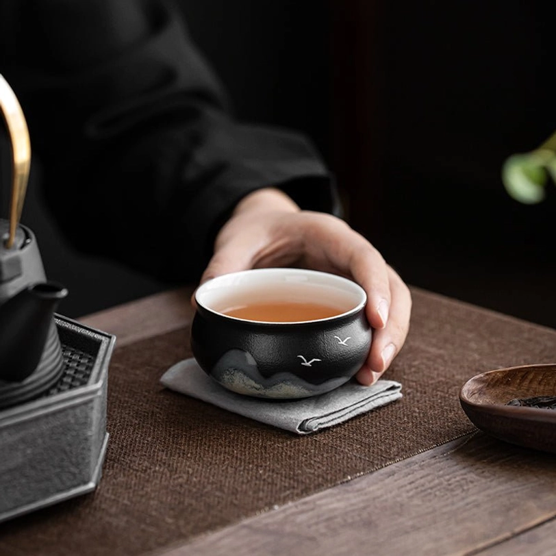 side view of matte black ceramic chinese tea cup
