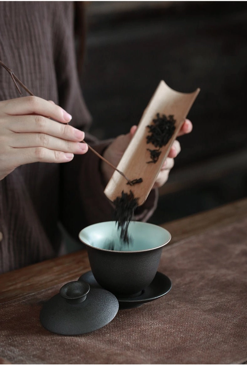 black clay gaiwan showing the saucer and bottom of the bowl