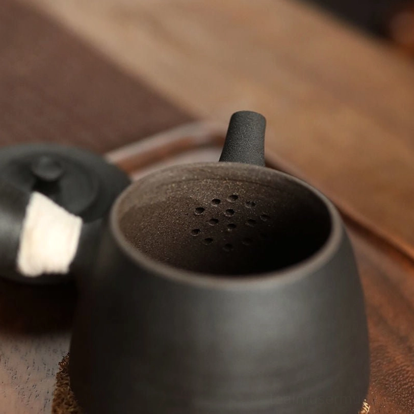 built-in filter holes inside black clay teapot for loose leaf tea