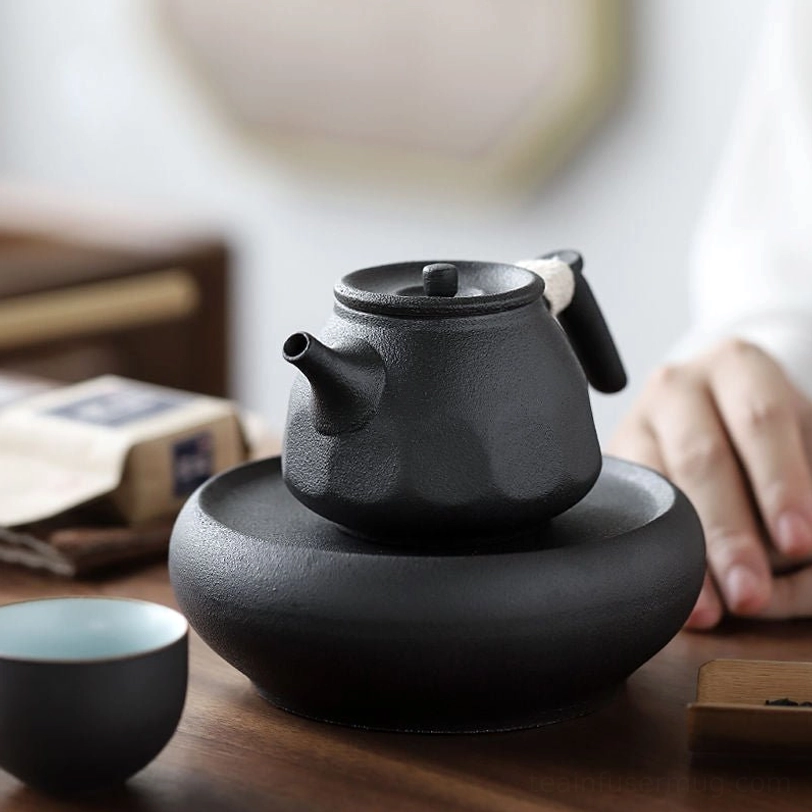 black clay teapot with rope wrapped handle and built-in infuser