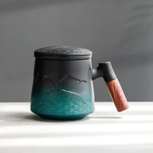 black-green gradient ceramic tea infuser mug with lid and strainer showing mountain relief pattern