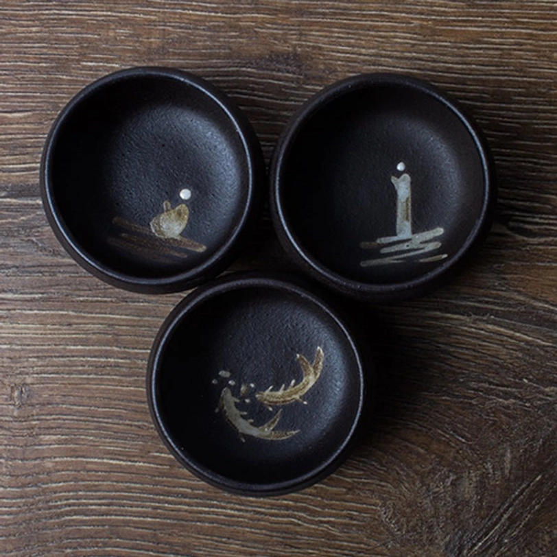 close up of rustic texture on black japanese ceramic tea cup
