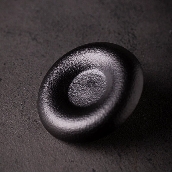 Close up of the textured matte exterior finish on the black Japanese tea cup
