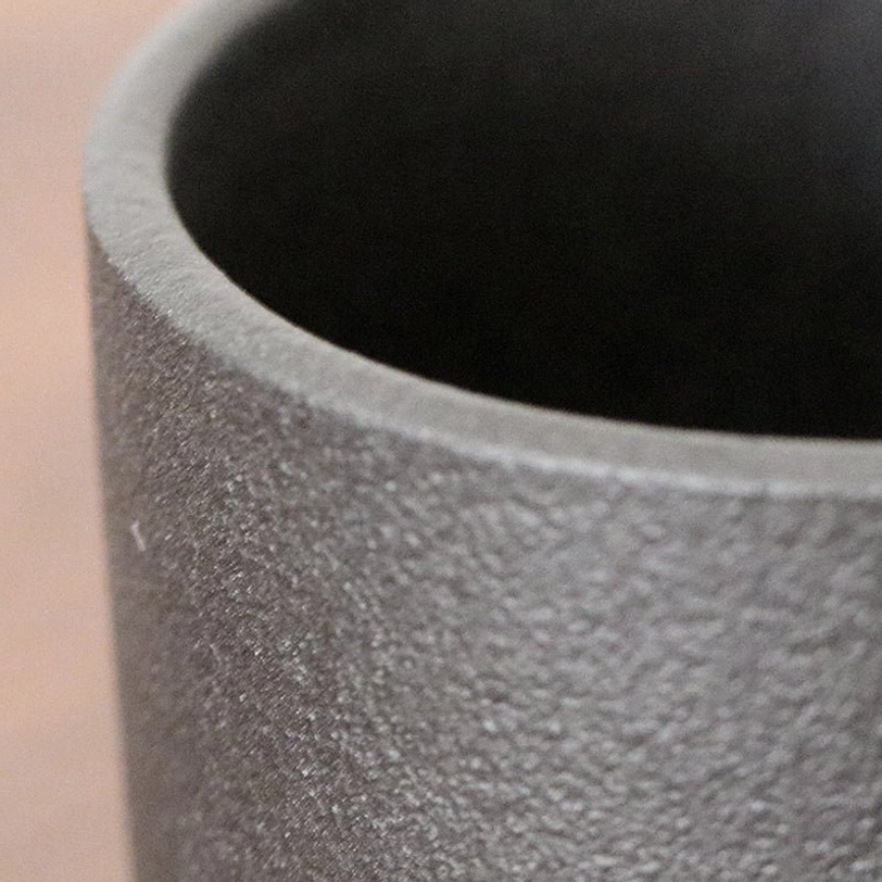 Close up of black matte ceramic tea storage canister texture