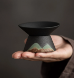 black mountain ceramic tea strainer with green landscape design