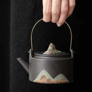 full view of black mountain pattern ceramic teapot with infuser