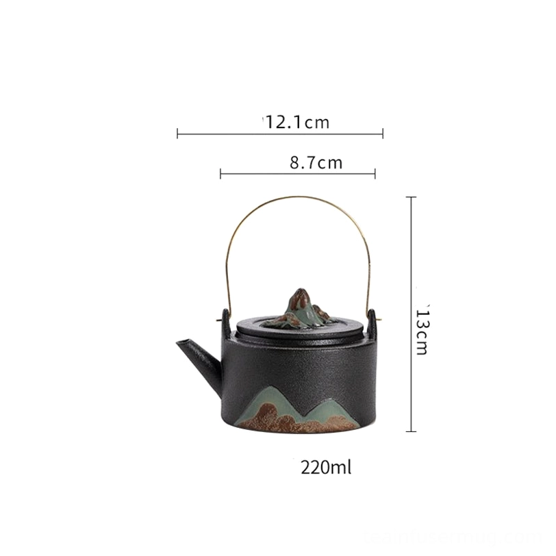 black mountain ceramic teapot with infuser next to matching tea cups