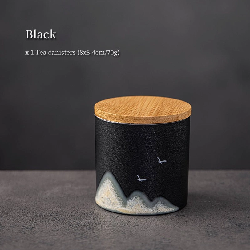 black tea storage canister showing white landscape and bird art details