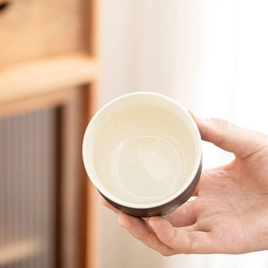 close up of lotus petal relief on base of black porcelain tea cup