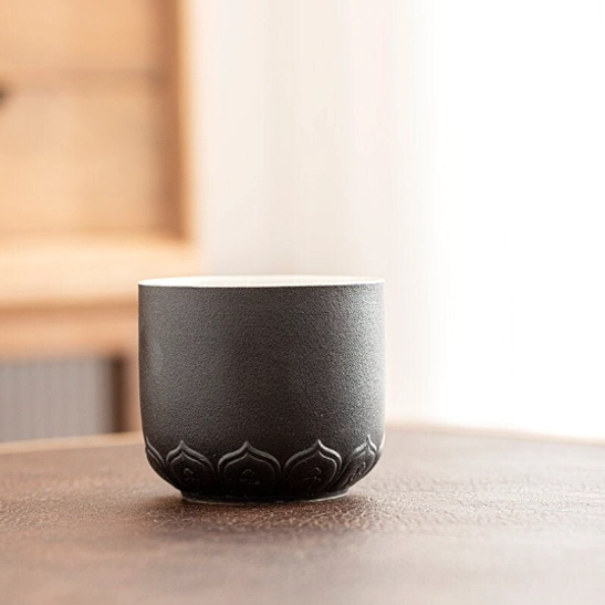side view of matte black chinese tea cup showing straight ergonomic shape