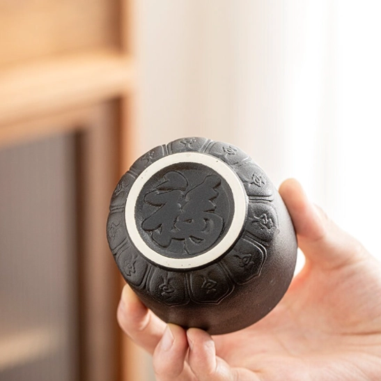 top view of black tea cup showing contrast between black exterior and white interior