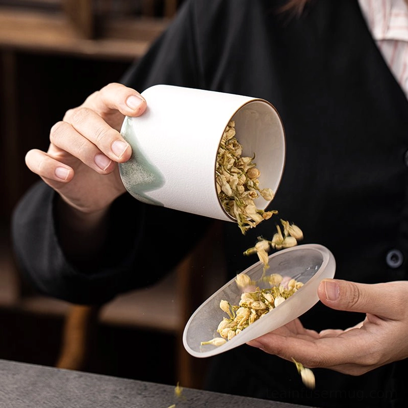 black ceramic tea storage canister placed on a wooden tea table