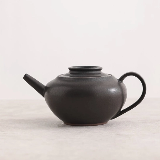 interior view of black teapot showing built-in infuser filter