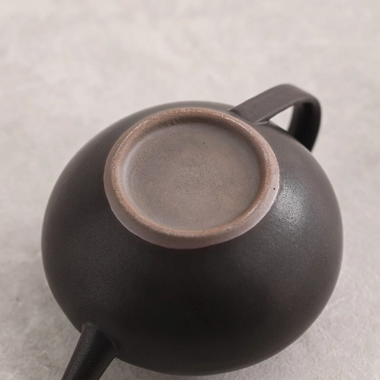 lid of black teapot close up view