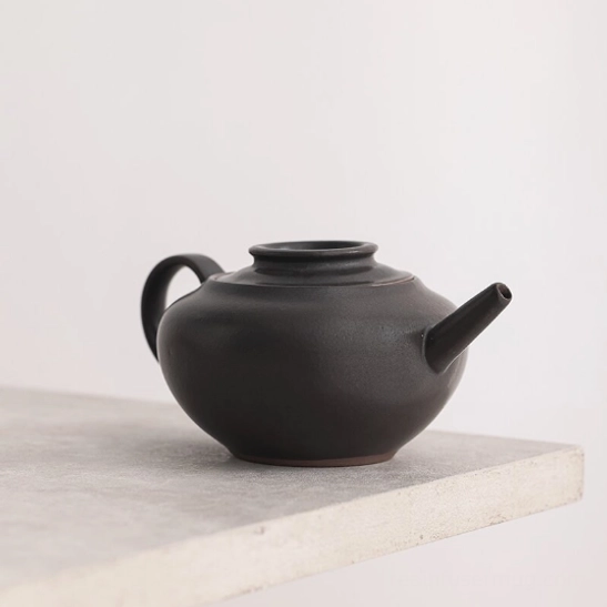 top view of black teapot showing lid and opening