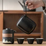 full opened black travel tea set with teapot, cups and accessories