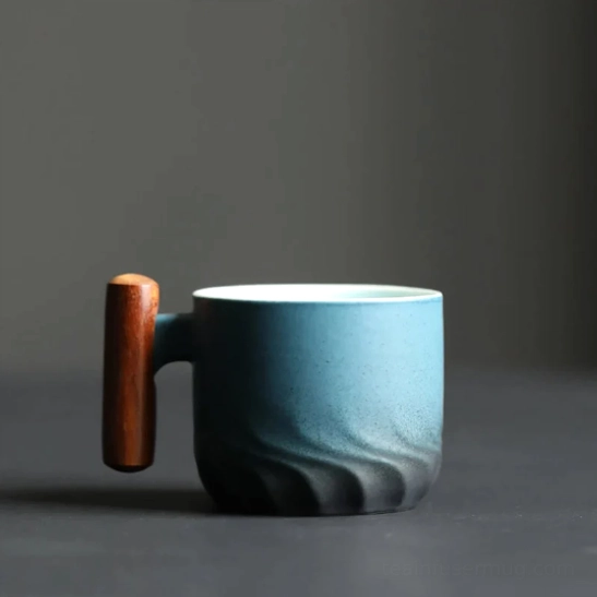 Blue gradient ceramic tea cup with wooden handle