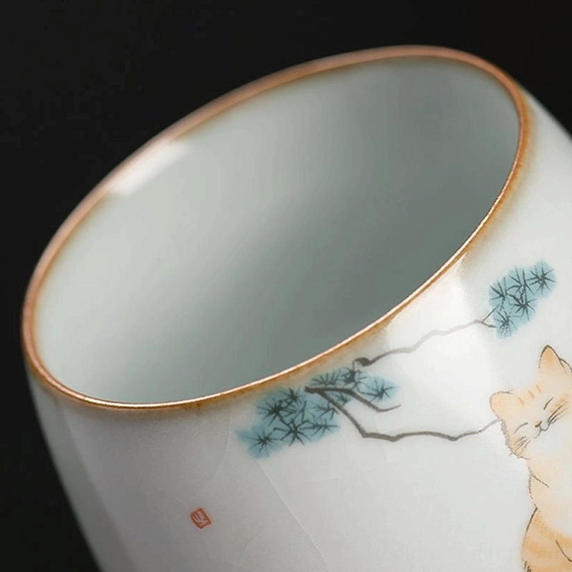close up of crackle glaze texture on cat motif chinese tea cup