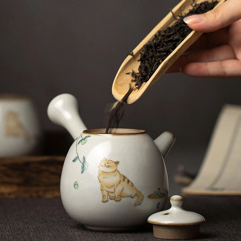 cute cat motif on ceramic kyusu teapot with crackle glaze detail
