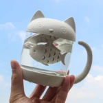 full front view of cat shaped glass tea infuser mug with fish infuser