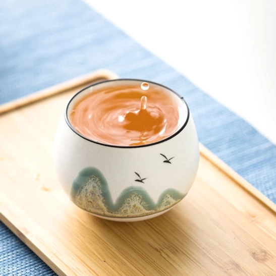 close up of black rim detail on ceramic mountain tea cup