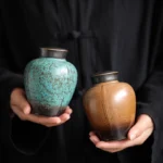 Handheld sealed ceramic tea storage caddy showing compact size