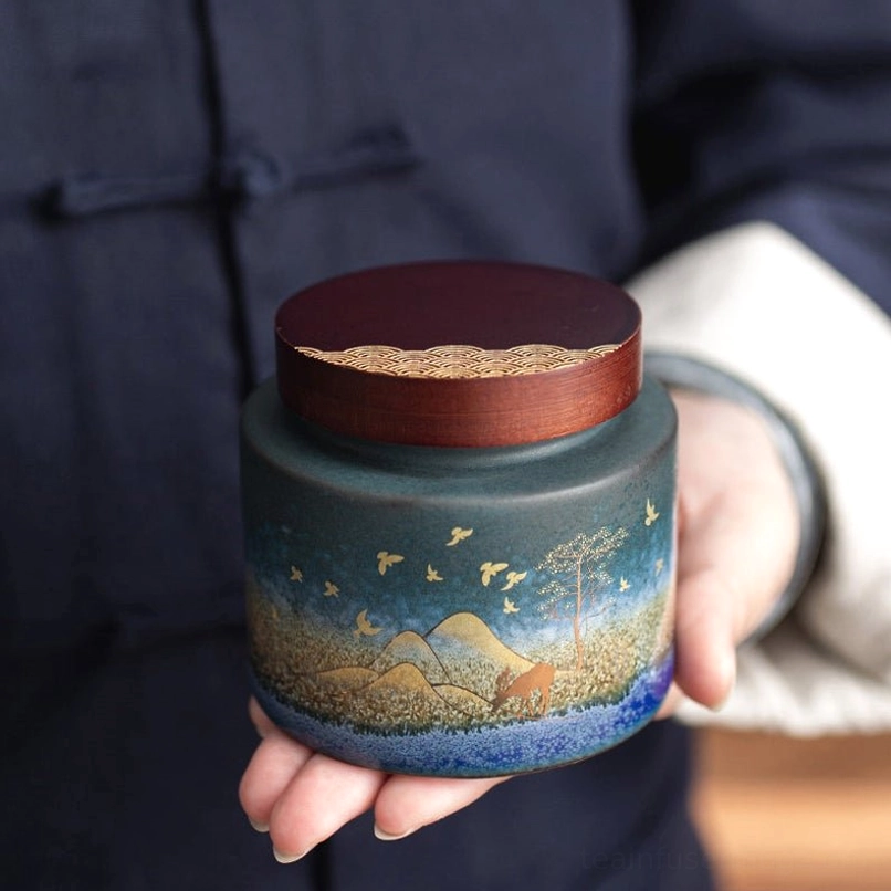close up of ceramic tea storage canister wood lid gold wave detail