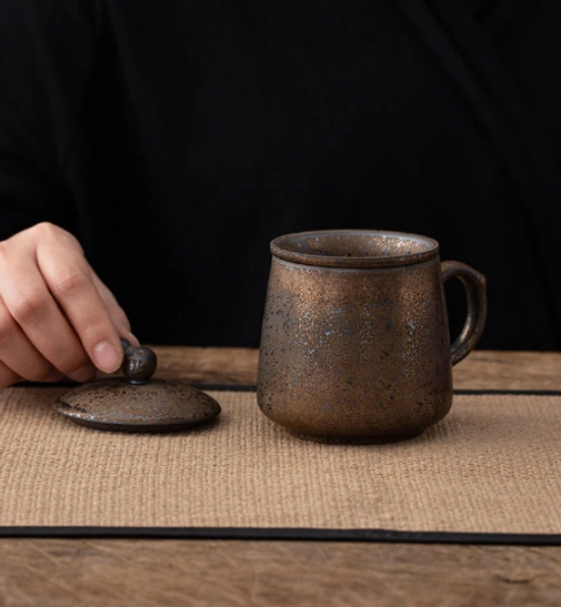 ergonomic handle of ceramic tea infuser mug with lid