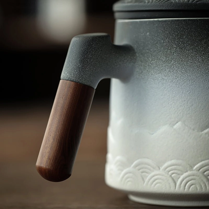 ceramic tea infuser mug displayed on an office desk