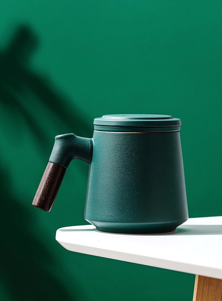 ceramic tea infuser mug placed on office desk for daily use