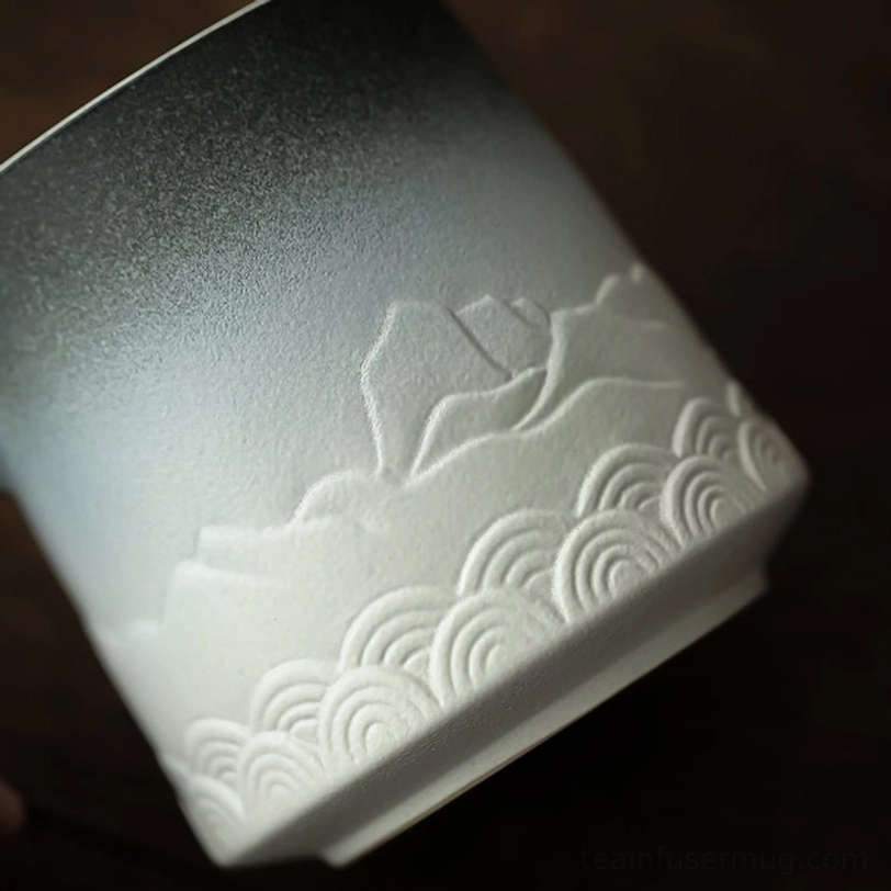 ceramic tea infuser resting on matching mug lid that doubles as an infuser tray