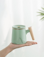 Full product shot of 300ml ceramic tea mug with infuser and wood handle