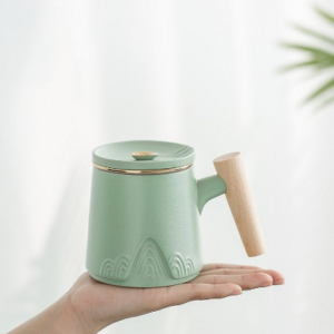 Full product shot of 300ml ceramic tea mug with infuser and wood handle